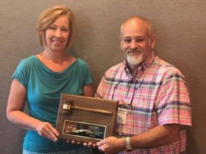 New IGIA President Becky Thomas presents out going President Mark McWilliams with his plaque.